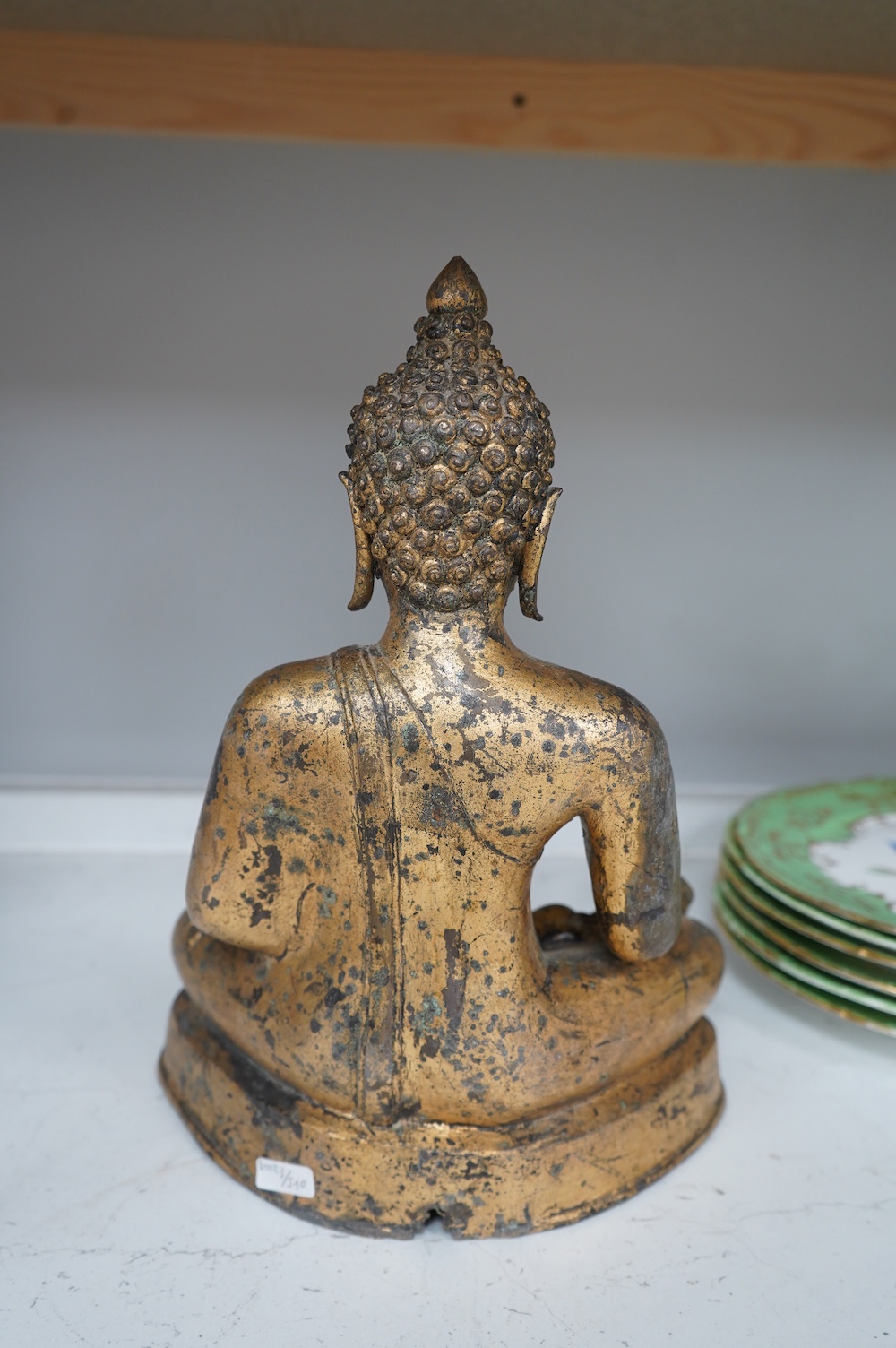 A Chinese gilt bronze figure of seated Buddha, 33cm high. Condition - fair, some holes